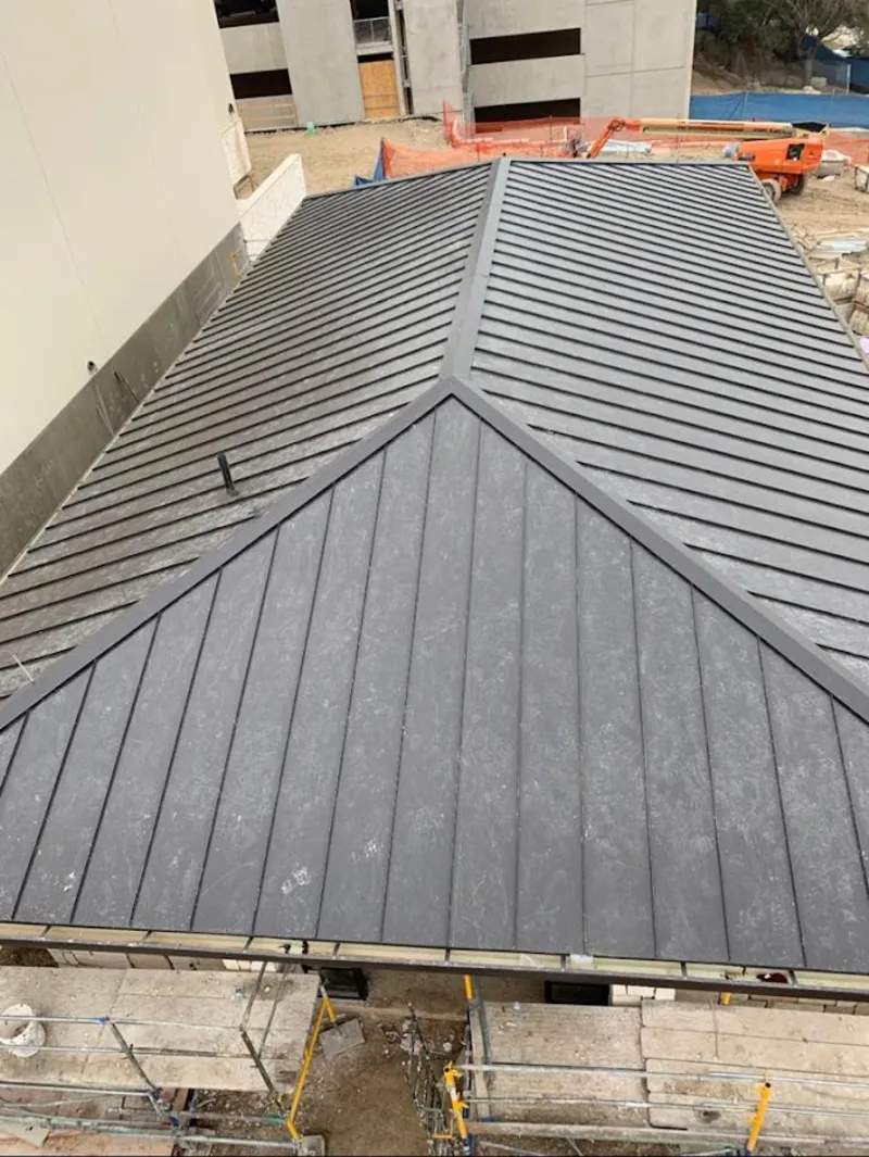 Commercial metal roof construction with crane equipment in Union